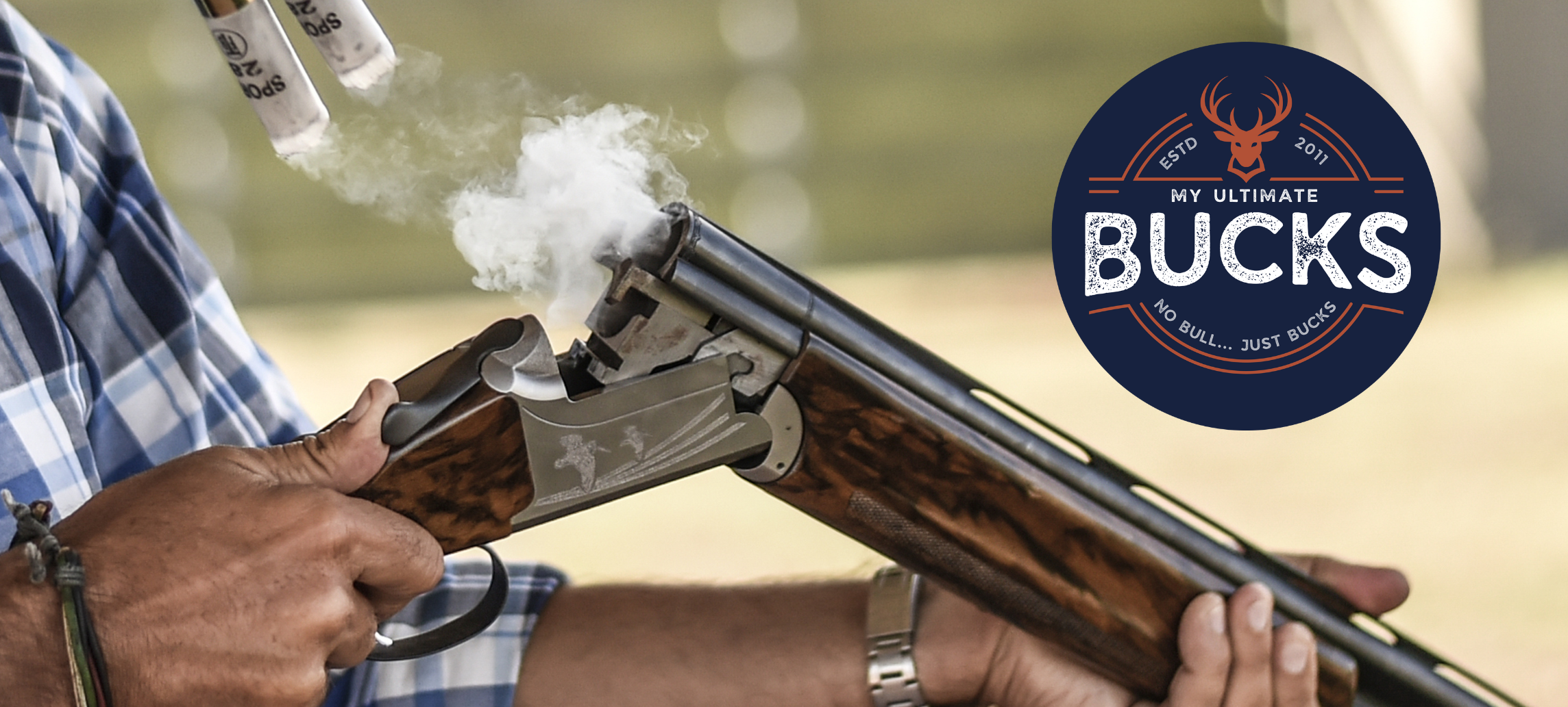 A smoking vertical double barrelled shotgun with the MyUltimate Bucks logo