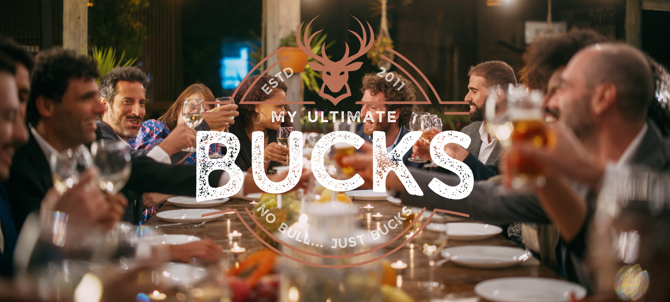 A long table with family on either side and the happy couple down the end, the MyUltimate Bucks logo over the top