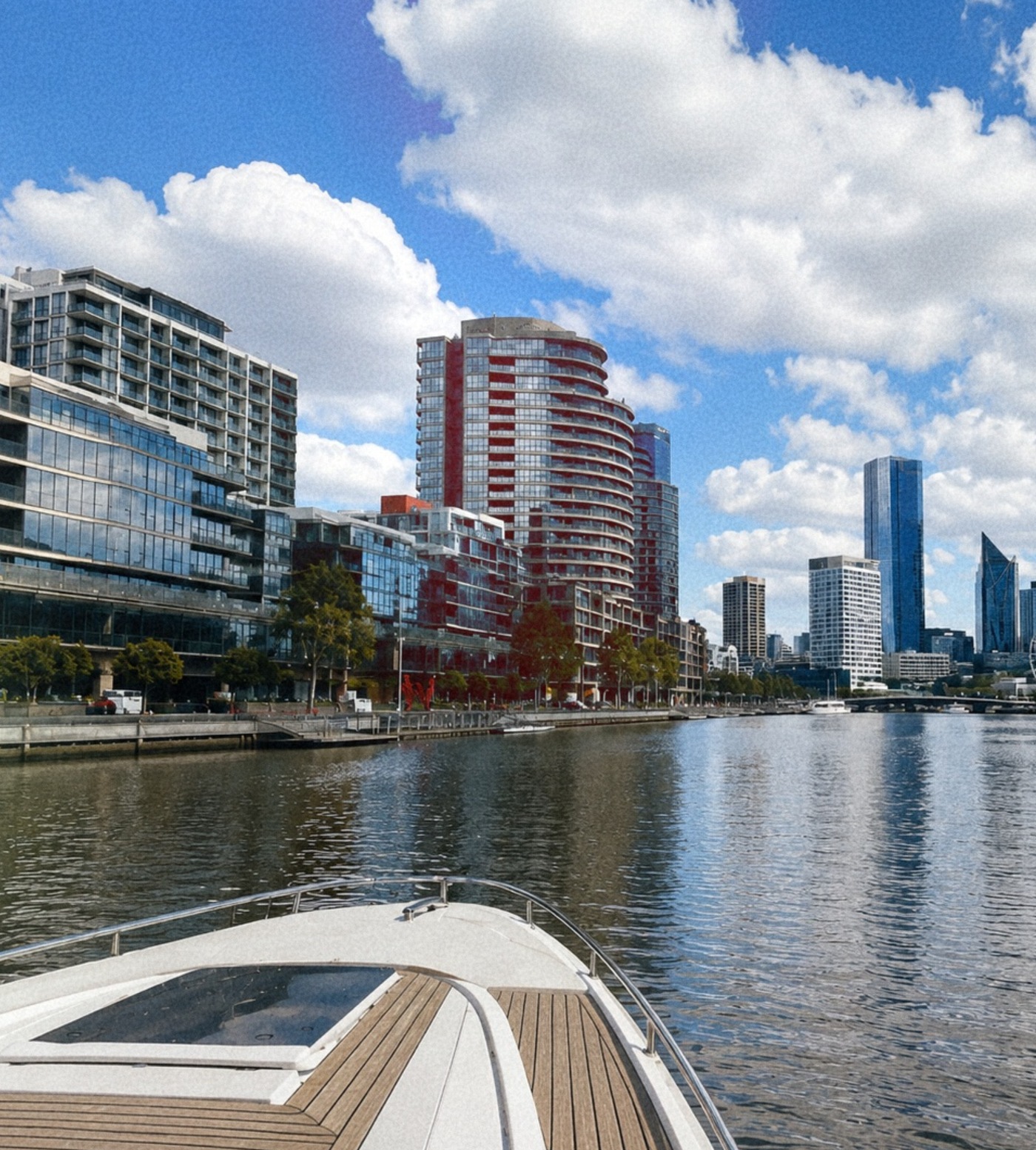 Boat on the Yarra with the Melbourne riverside towers behind