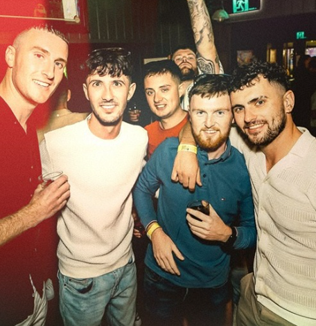 A group of mates celebrating together during a bucks party dinner