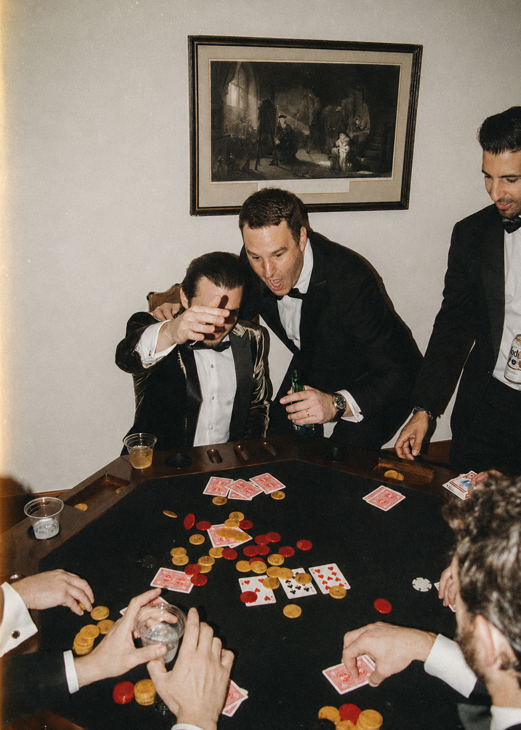A bucks weekend group in black tie around a card table