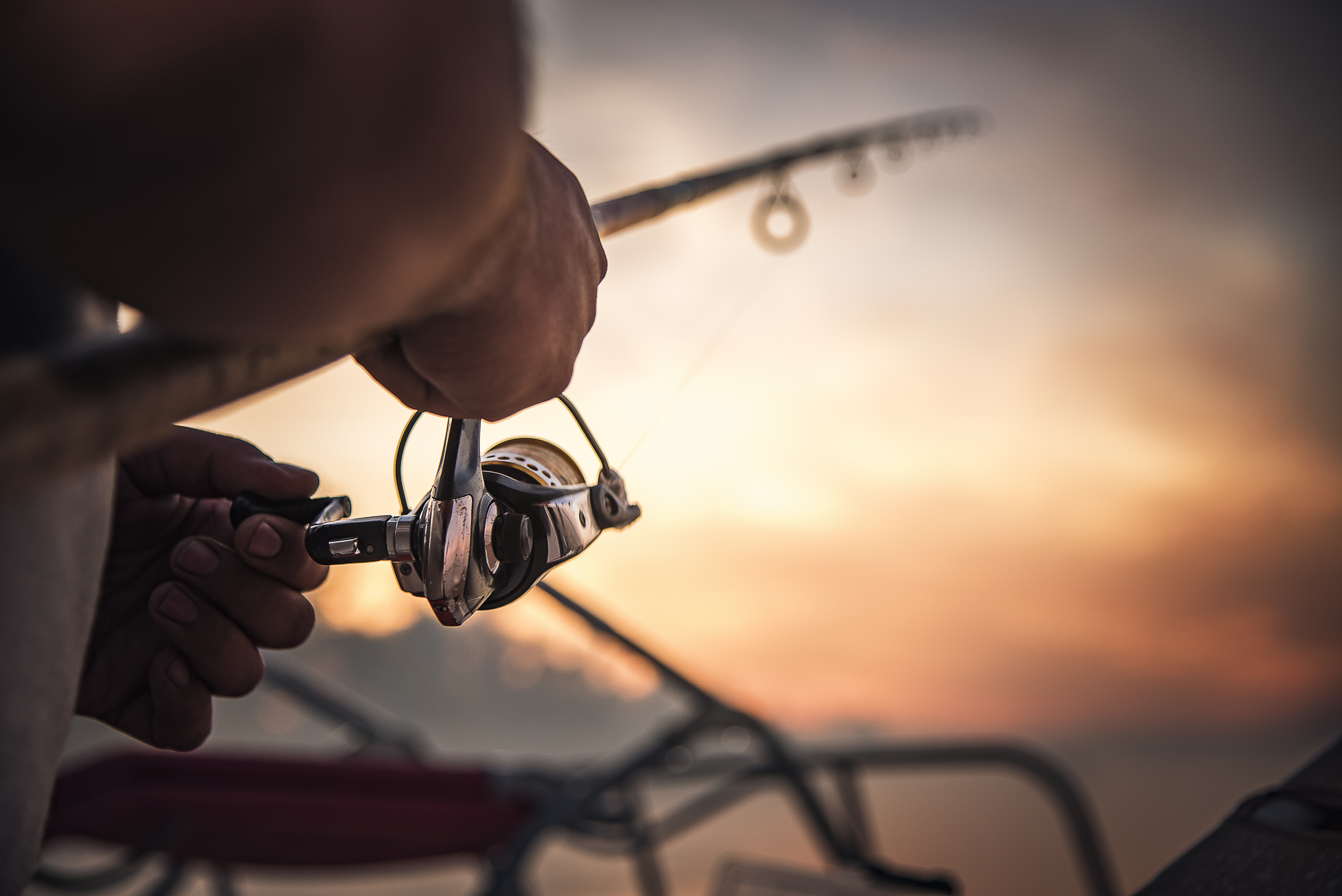 A fishing rod against a sunset