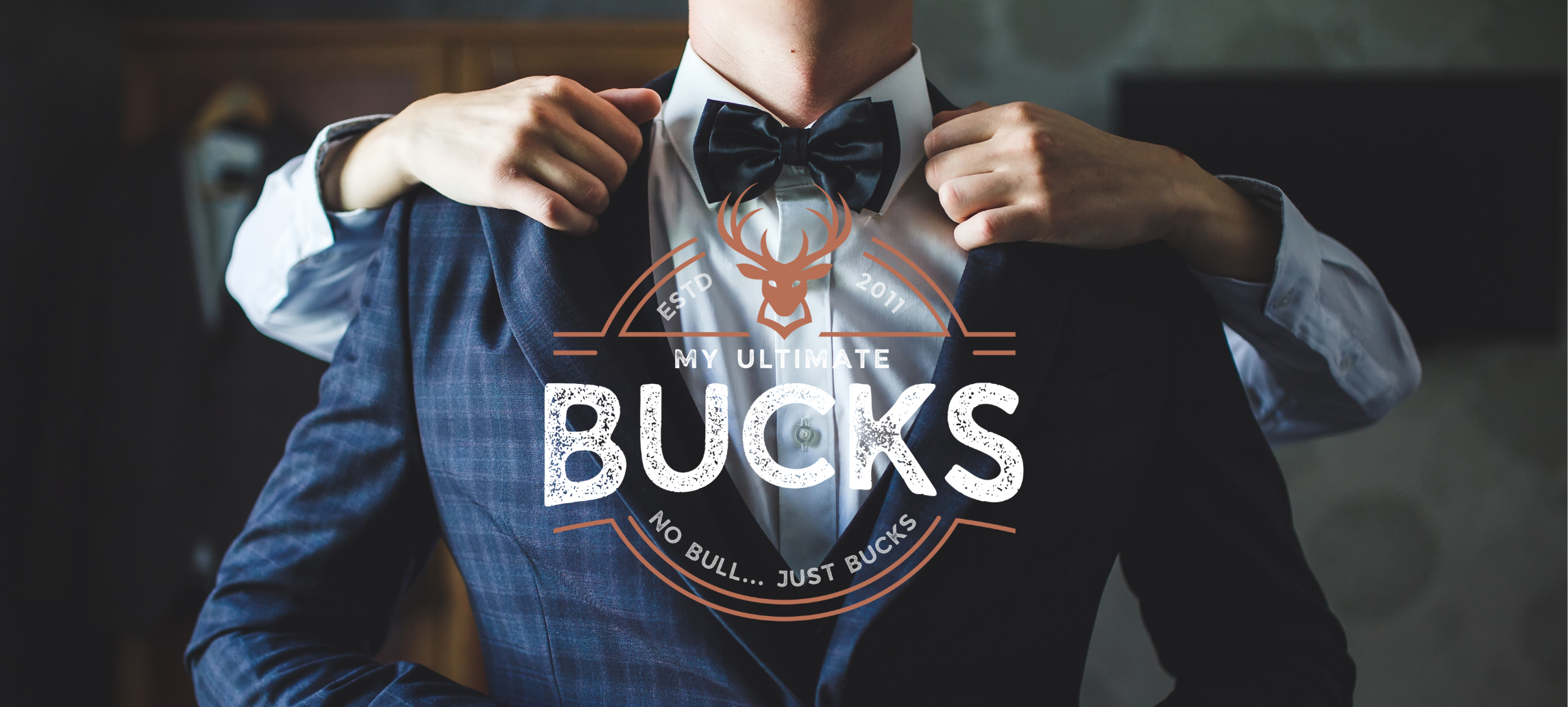 A best man being dressed by his groomsman with the MyUltimate Bucks Logo