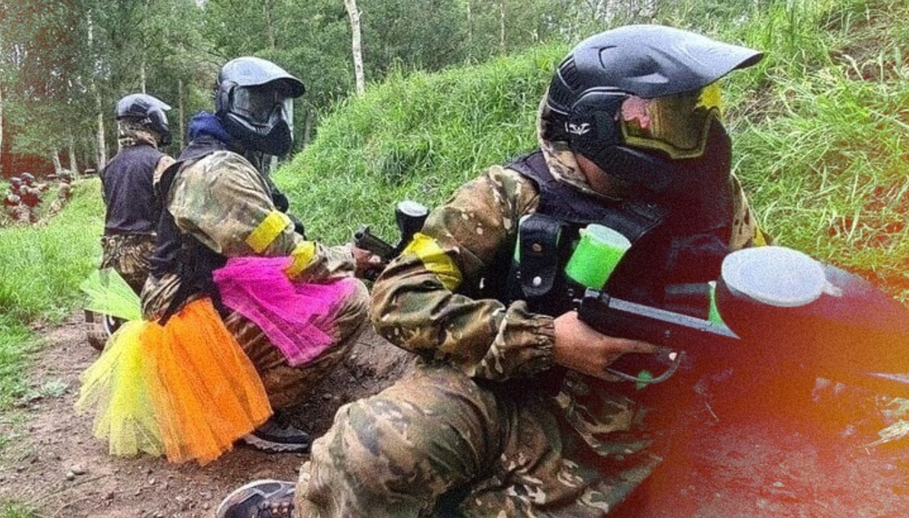Bucks party guests in paintball gear, one in a tutu, at a Melbourne paintball session