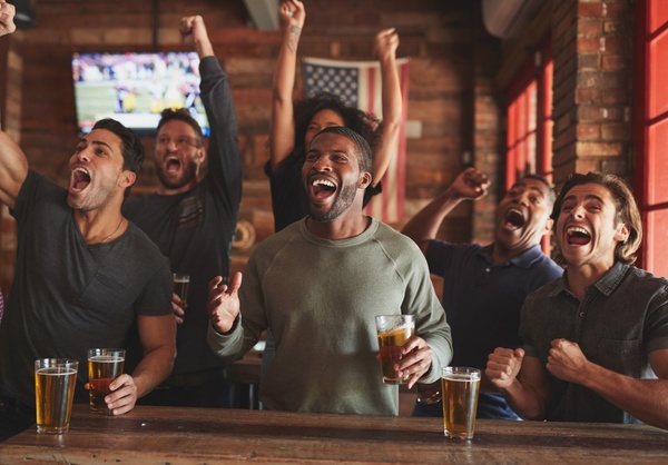 A crew cheering at a sports bar