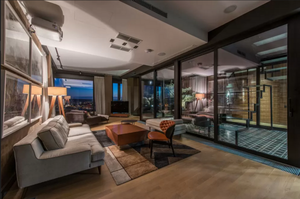An apartment living room with floor-to-ceiling windows