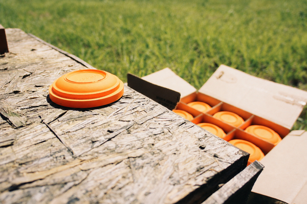 Orange clay targets on a wooden bench