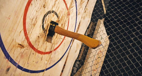 An axe stuck in the centre of a painted target