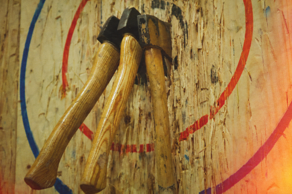 Two axes buried in a painted wooden target