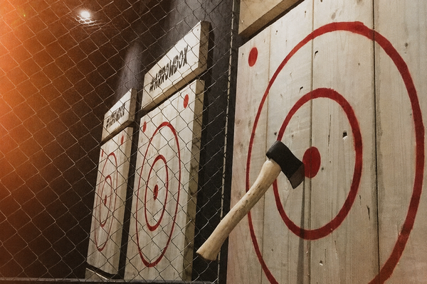 An axe sunk into a red bullseye target