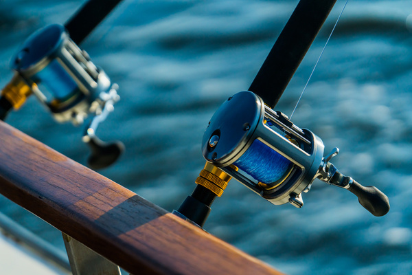 A fishing reel on a rod above the water