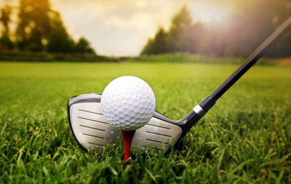 A driver lined up behind a teed-up ball