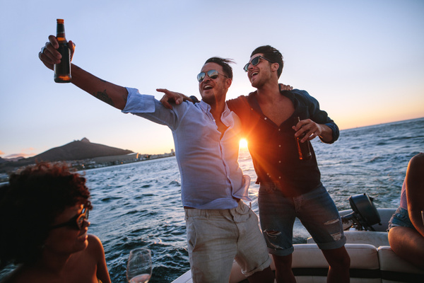 Mates taking a selfie on a boat at sunset