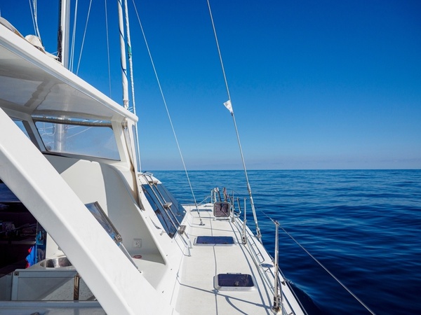 The deck of a yacht out on open blue water