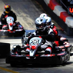 Karts racing on an outdoor track