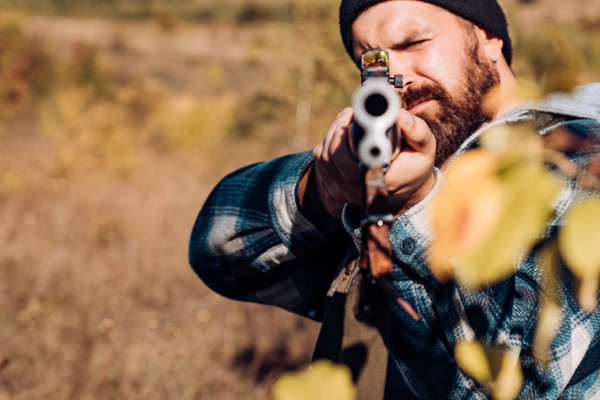 A shooter aiming a shotgun