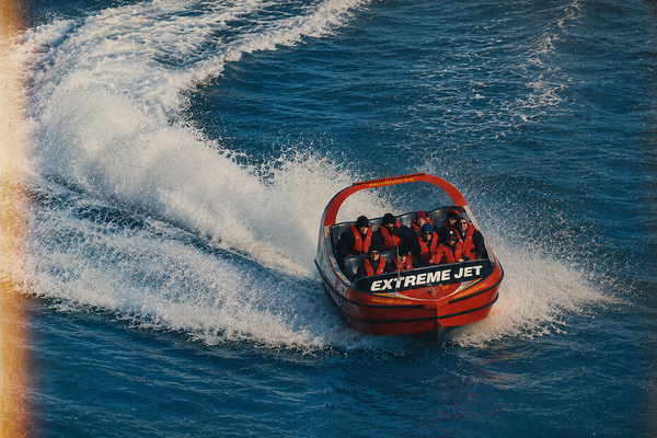 A jet boat carving a tight turn across open water