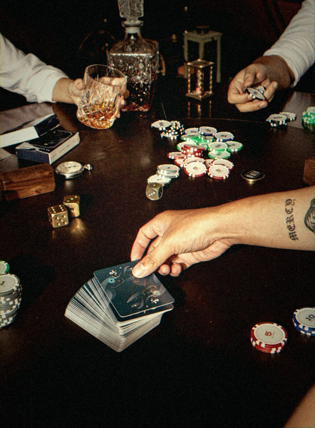 Hands dealing cards and stacking chips at a poker table