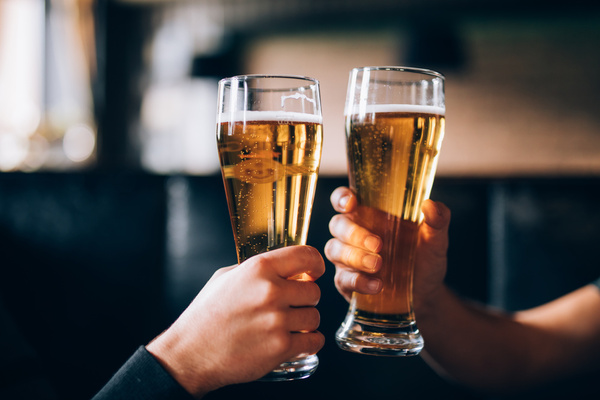 Two pints raised in a toast