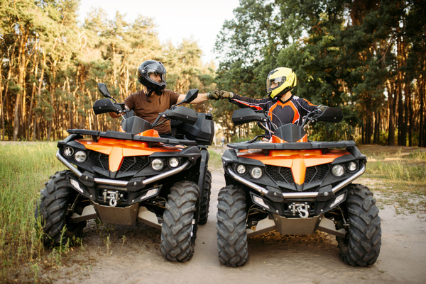 Two quad bikes side by side on a bush track
